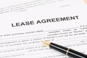 A Lease Agreement With A Pen On Top Of The Paper 